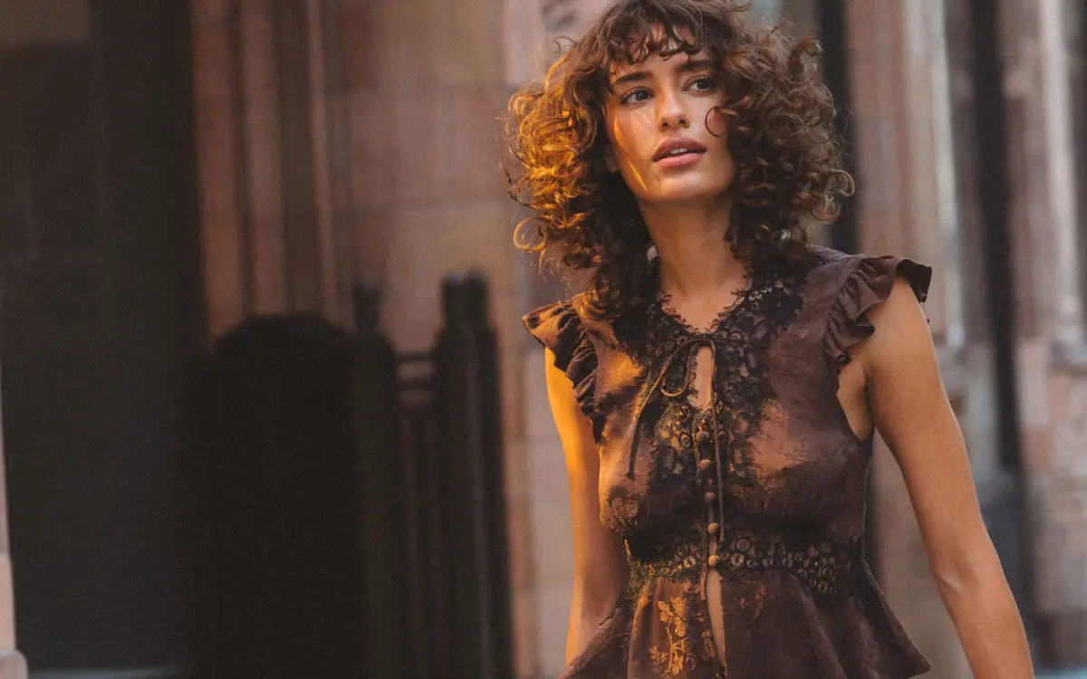 Rumored campaign photograph of a model in a lace blouse
