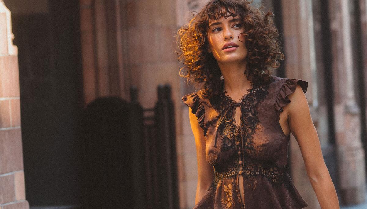 Rumored campaign photograph of a model in a lace blouse